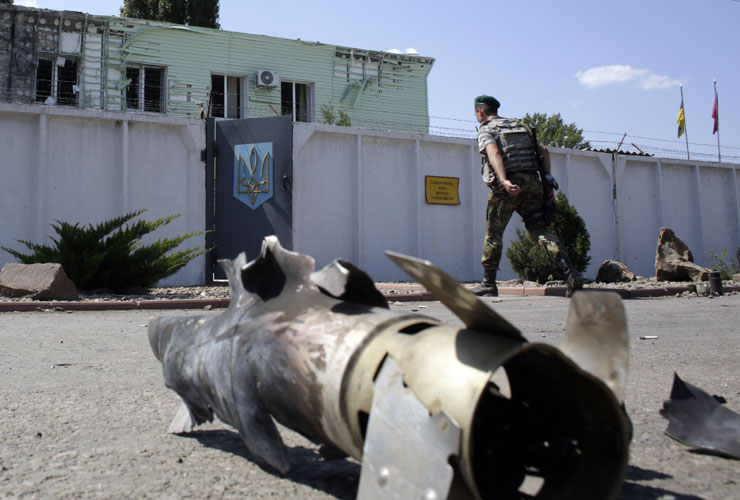 The wreckage of a rocket lies on a street in Luhansk