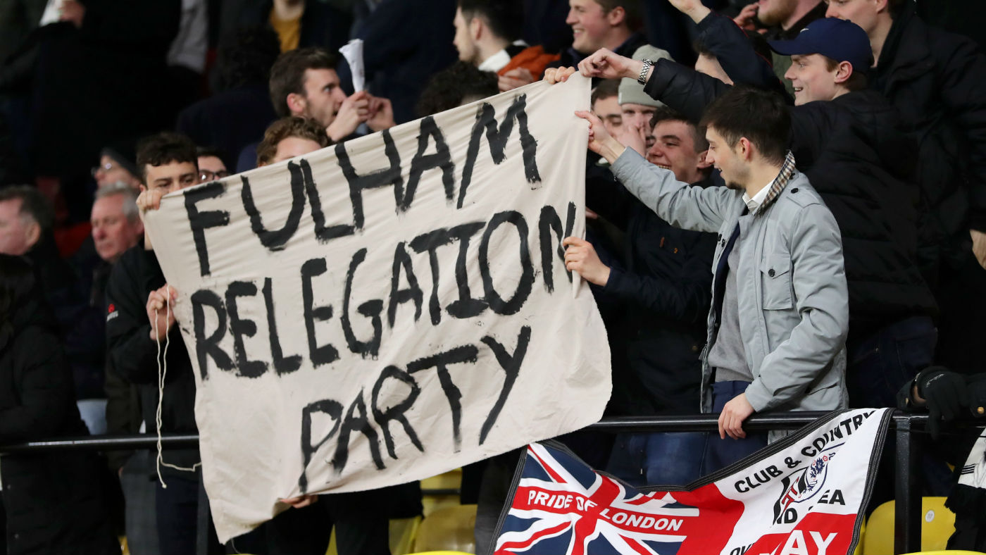 Fulham fans hold up their banner after being relegated at Watford’s Vicarage Road