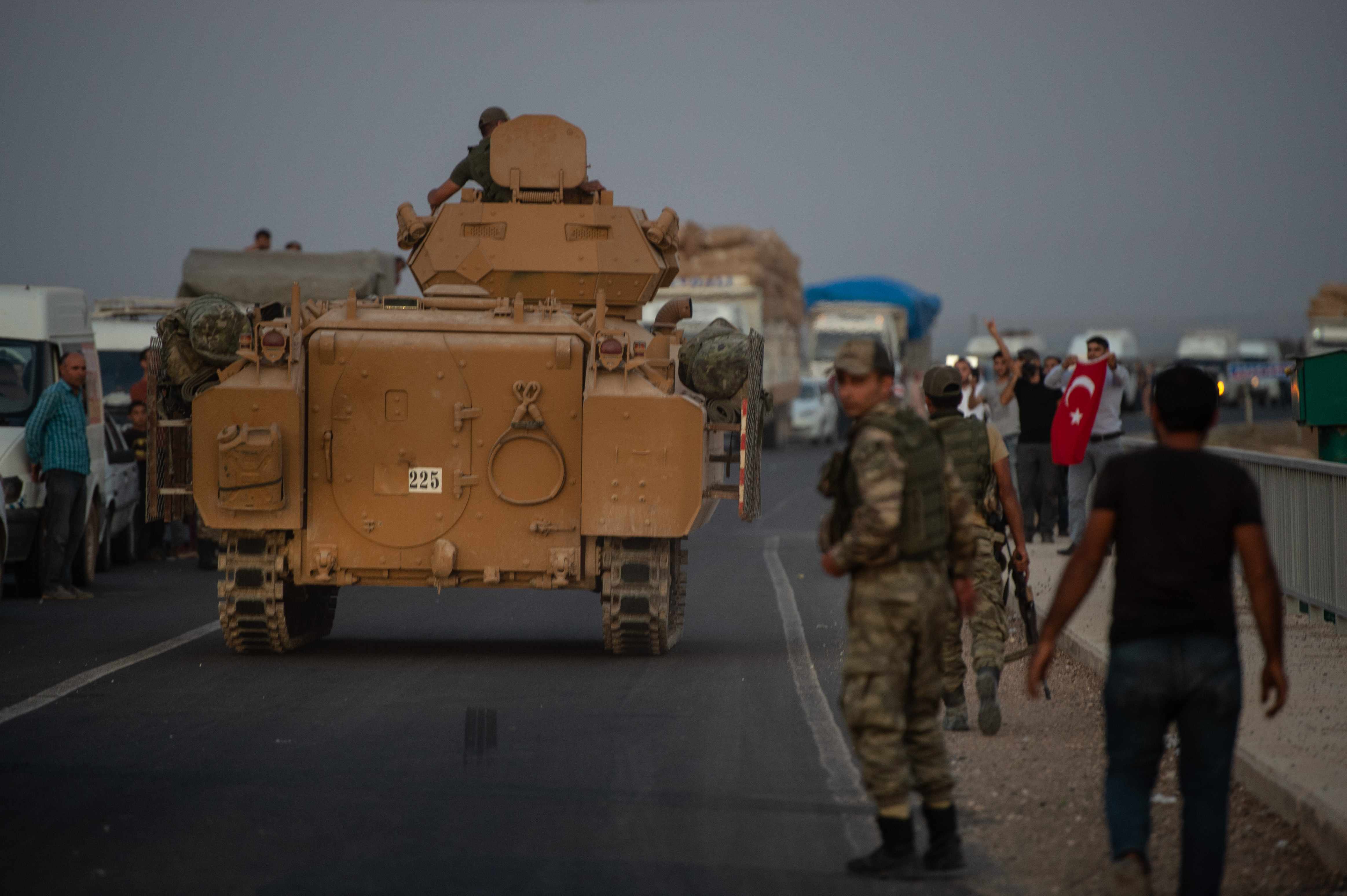 AKCAKALE, TURKEY - OCTOBER 09: People wave as Turkish soldiers prepare to cross the border into Syria on October 09, 2019 in Akcakale, Turkey. The military action is part of a campaign to ext