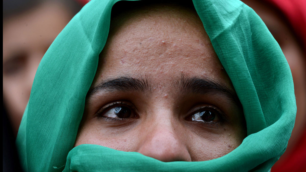 A Kashmiri woman cries during a protest against a police officer who allegedly shot dead a local teenager