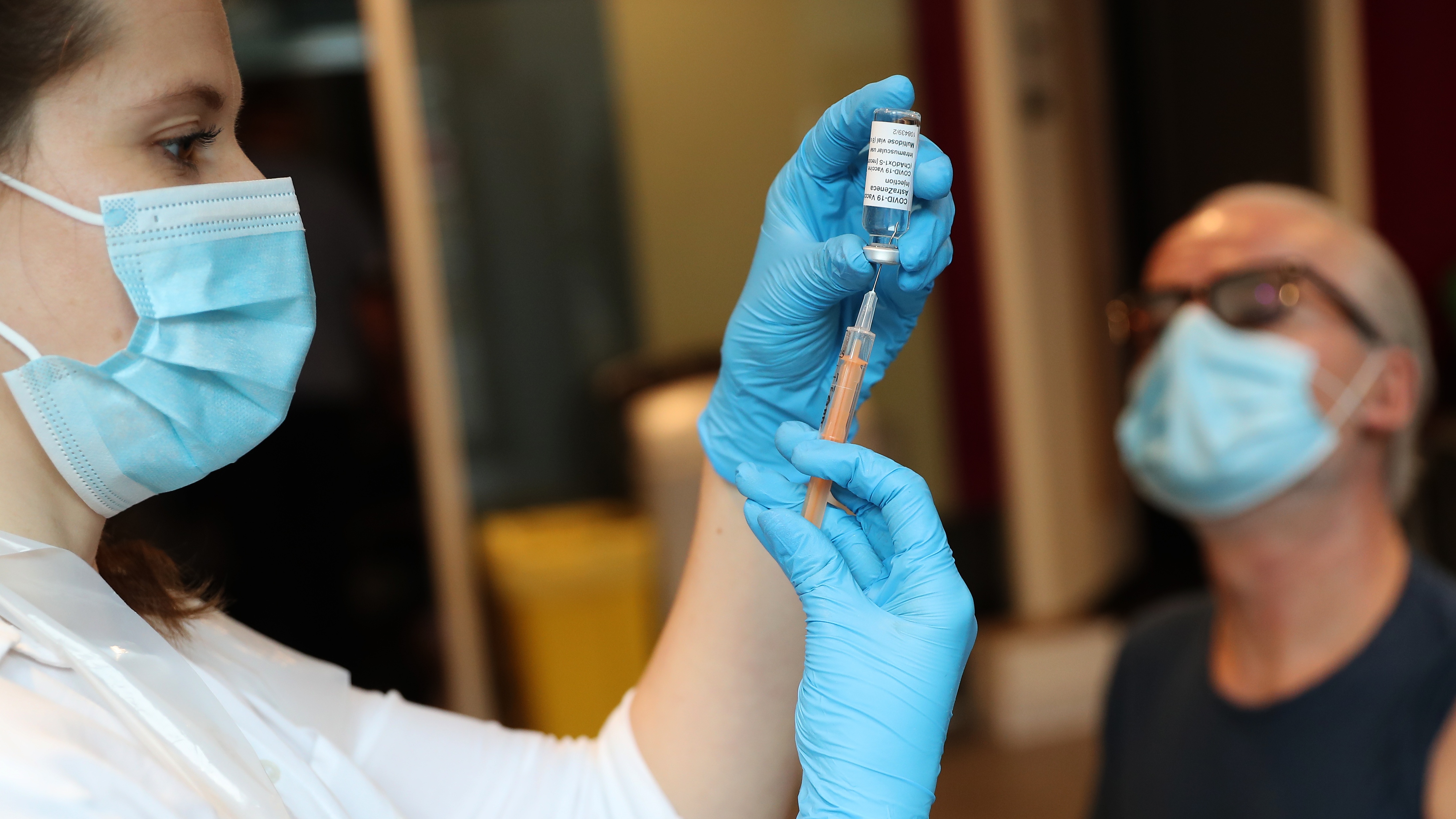 A pharmacist prepares to administer the Oxford-AstraZeneca vaccine at Kingston University