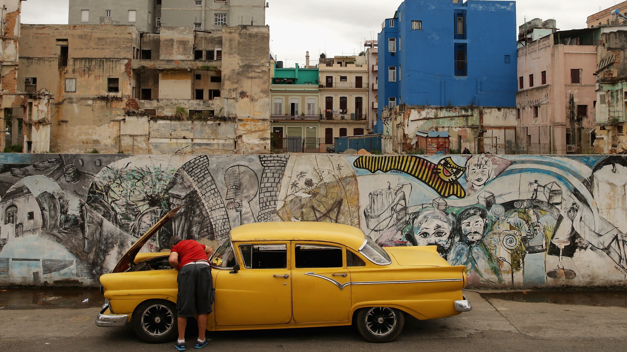 A man repairs his car in Havana, Cuba