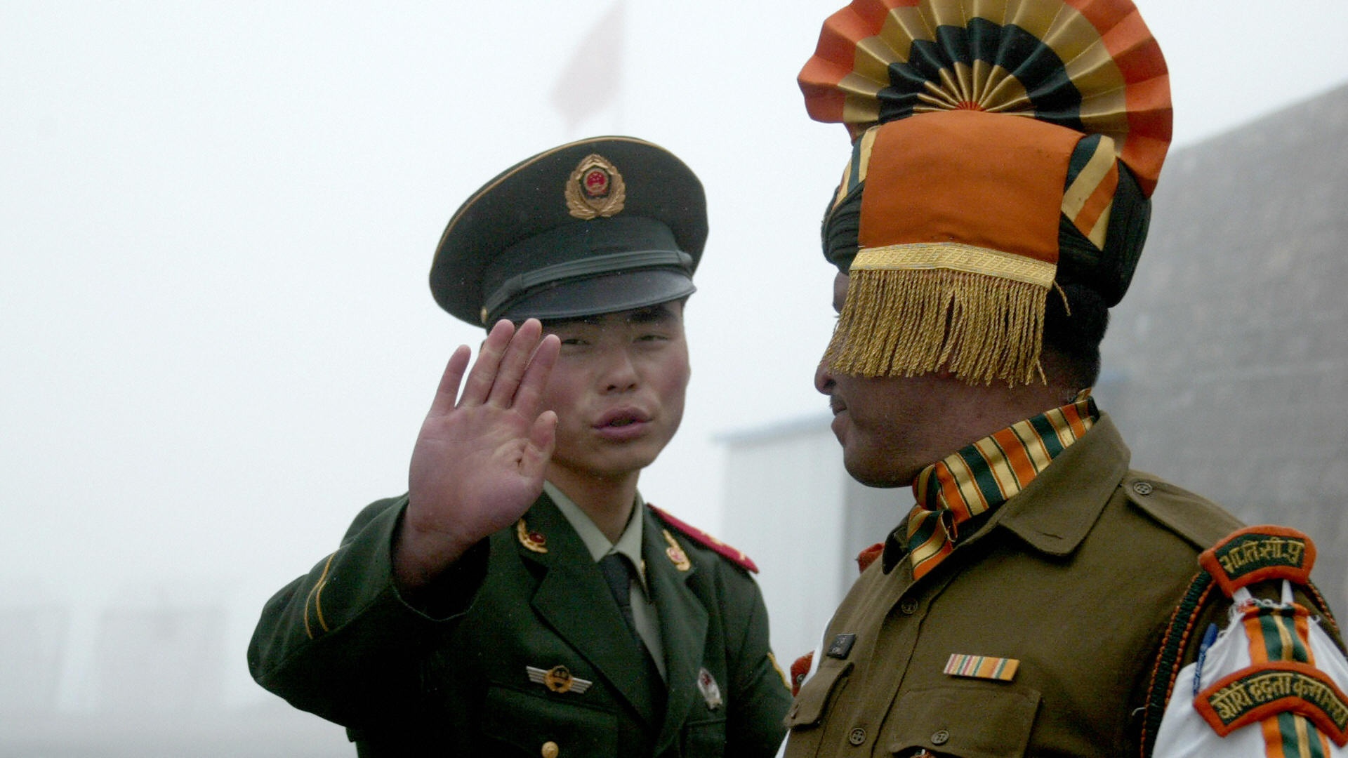 A Chinese and an Indian border guard at the Nathu La crossing