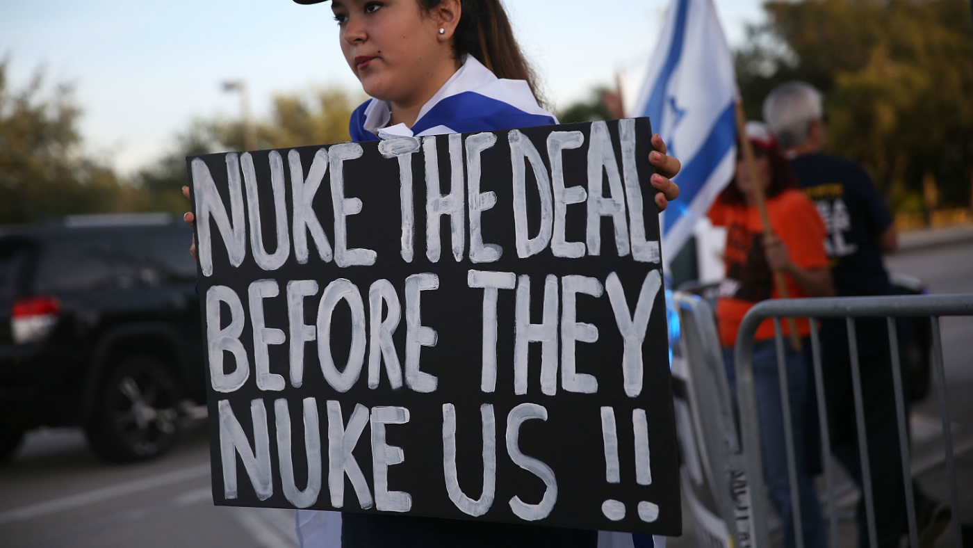A demonstrator holds a sign calling for the US to &quot;nuke&quot; Iran before it can take nuclear action against the US.