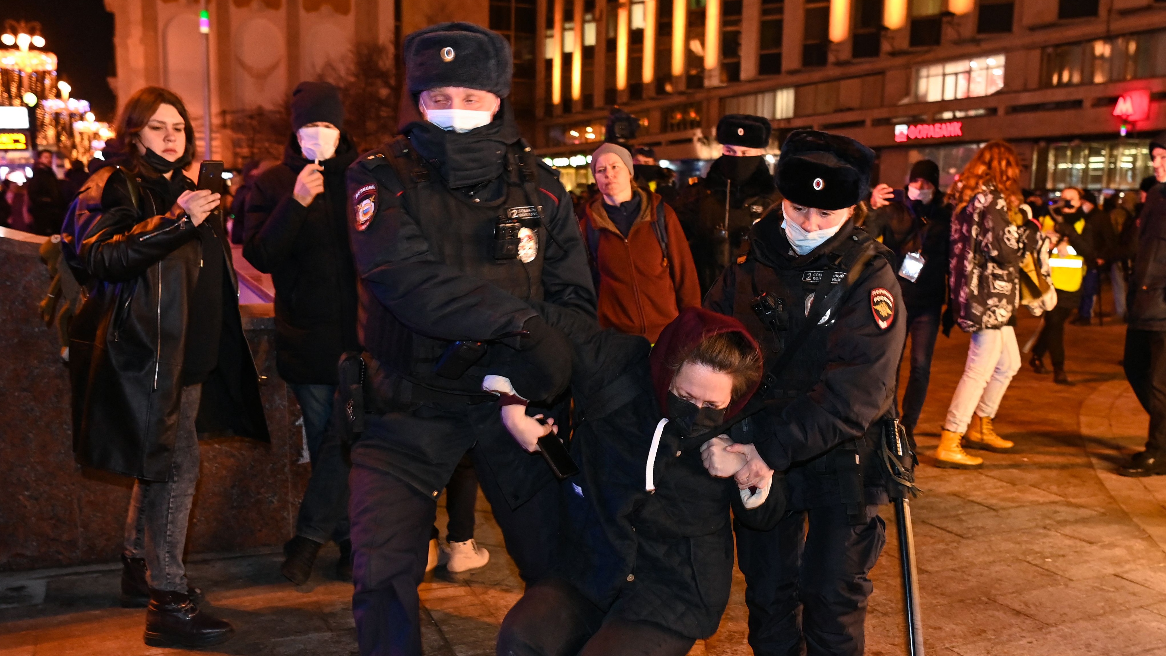 Police detain a woman at an anti-war demonstration in Moscow