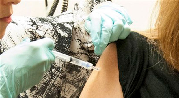 A doctor is giving a vaccine
