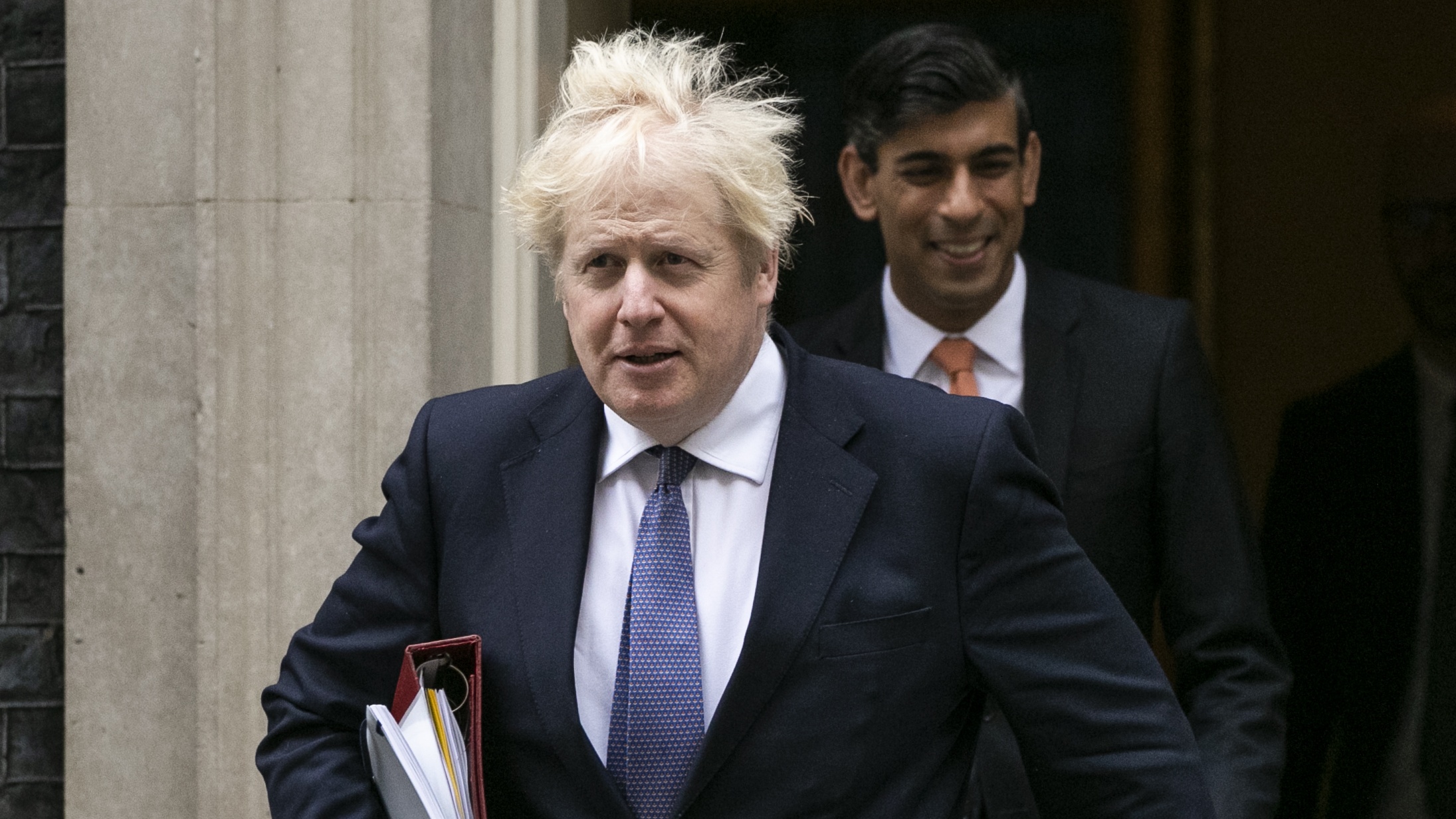 Boris Johnson leaves Downing Street flanked by Chancellor Rishi Sunak