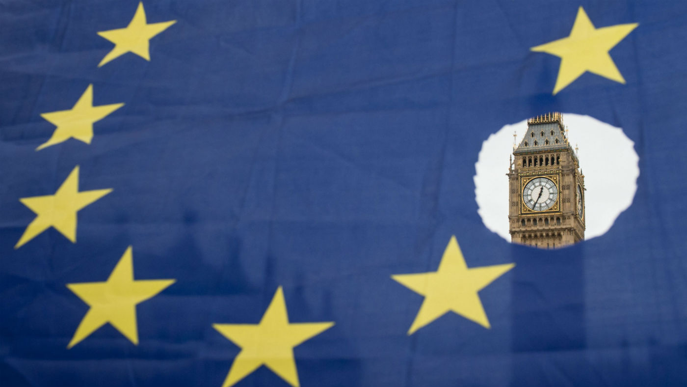 The Houses of Parliament seen through an EU flag