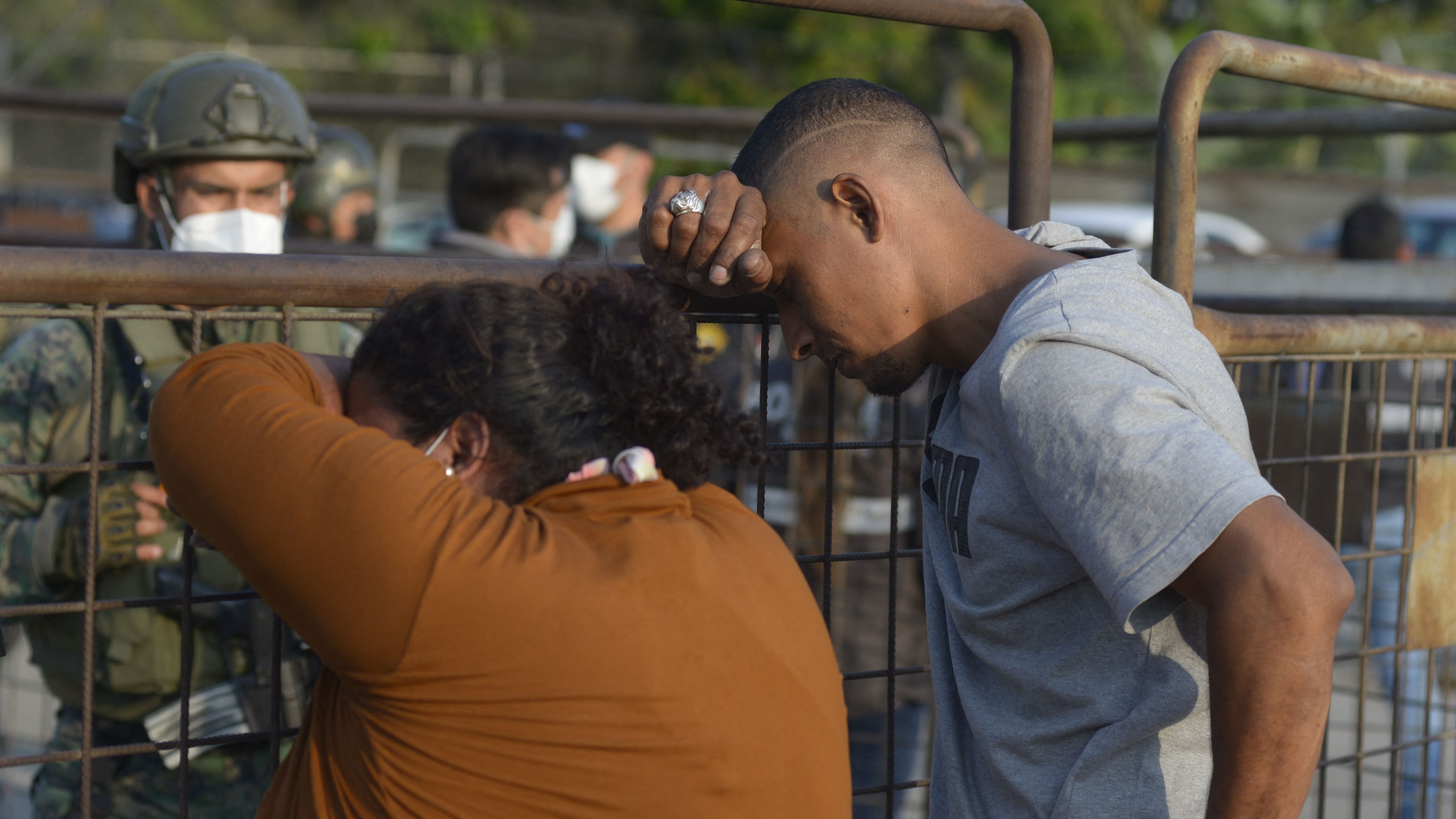 Relatives of inmates wait for news after a prison riot in Guayaquil, Ecuador