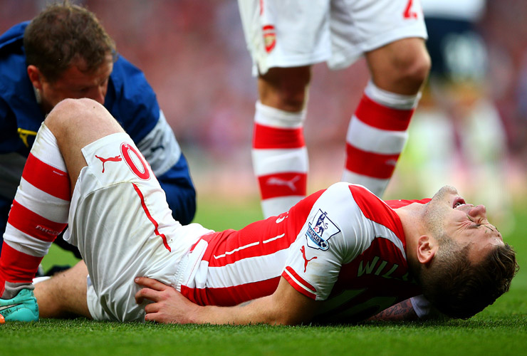 Jack Wilshere of Arsenal receives treatment during the Barclays Premier League match between Arsenal and Tottenham Hotspur