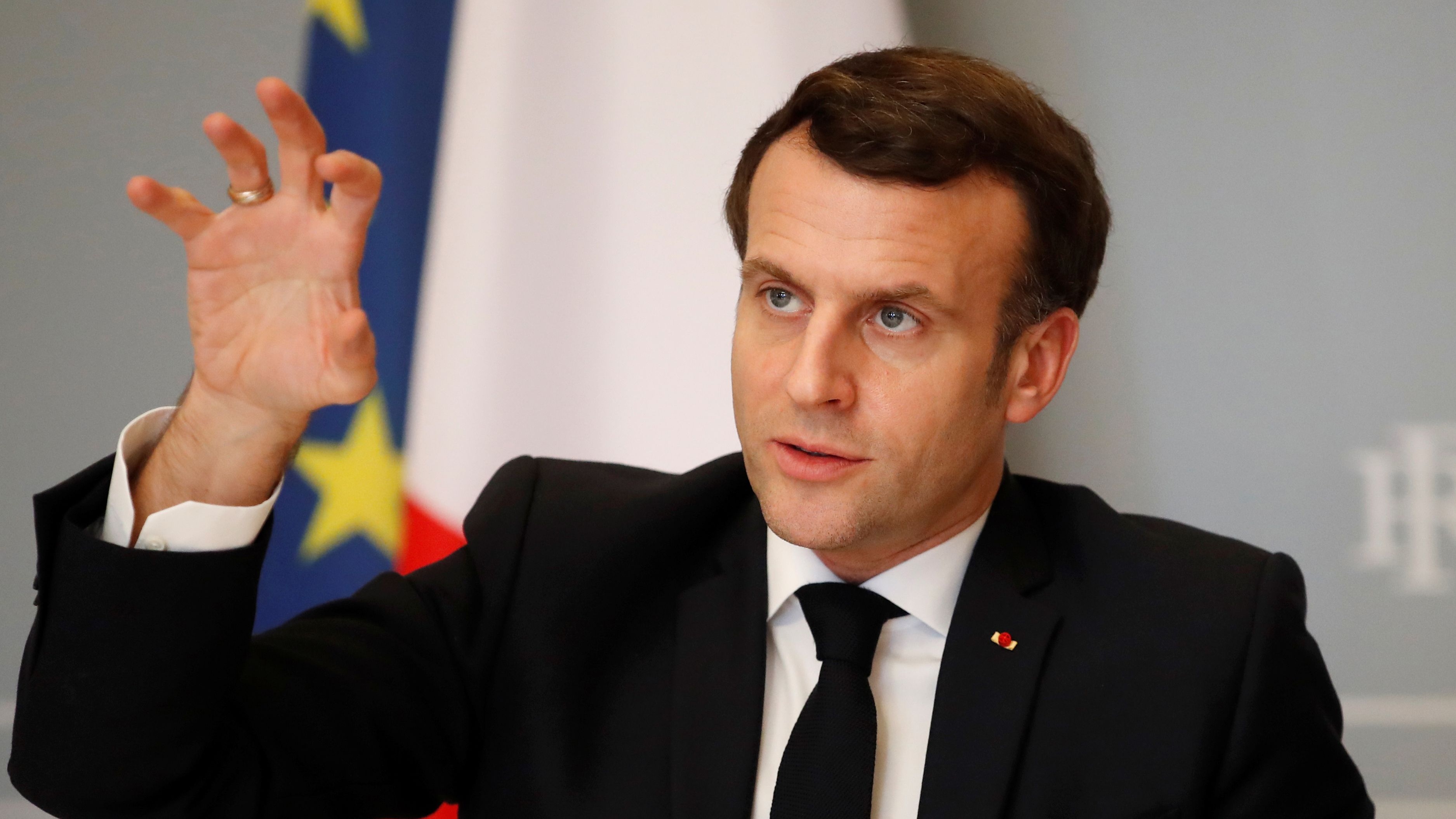 Emmanuel Macron gestures as he speaks during a video conference meeting.