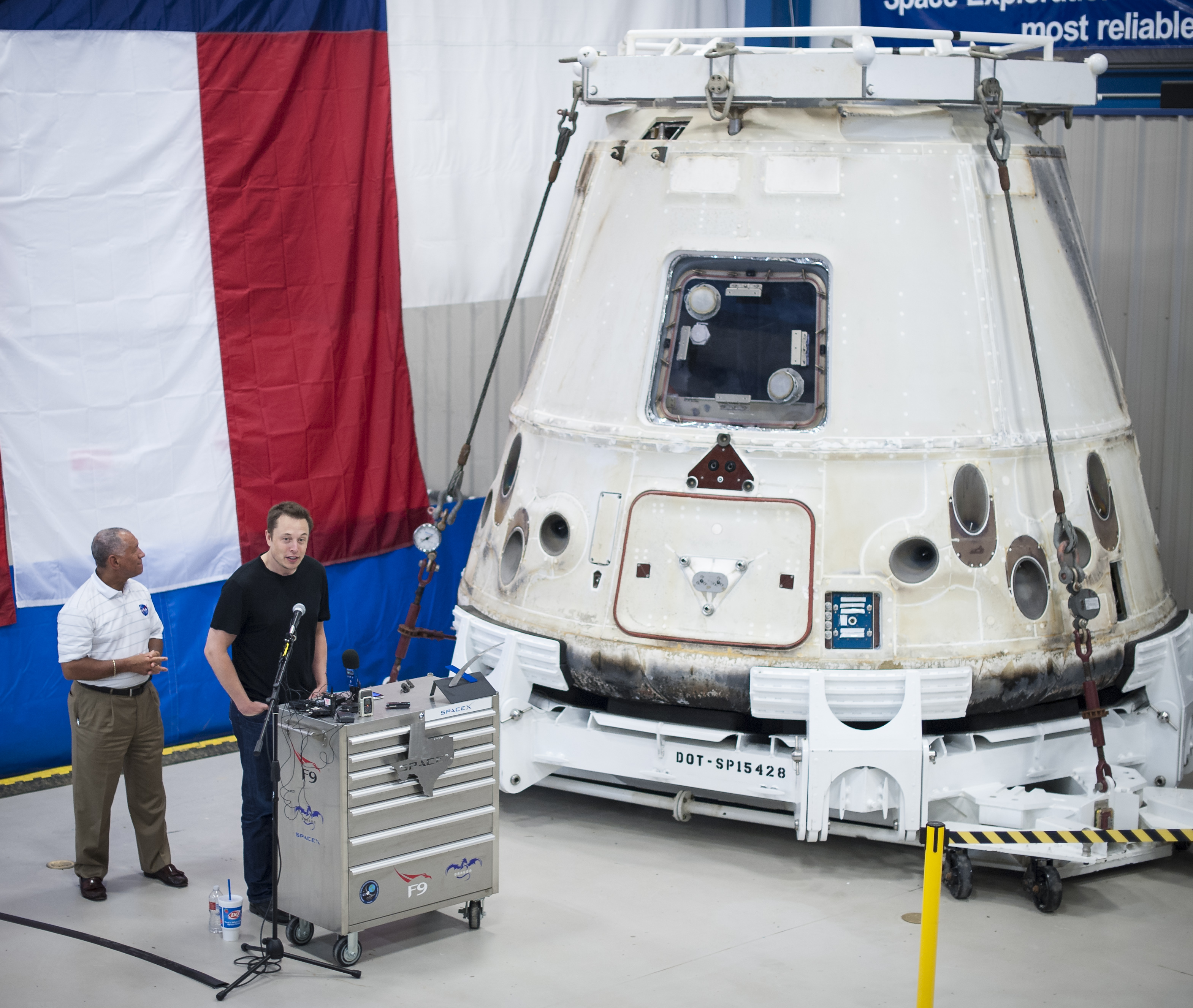 MCGREGOR, TX - JUNE 13:In this handout from NASA, SpaceX CEO and Chief Designer Elon Musk (R) speaks as NASA Administrator Charles Bolden, listens next to the Dragon capsule at the SpaceX fac