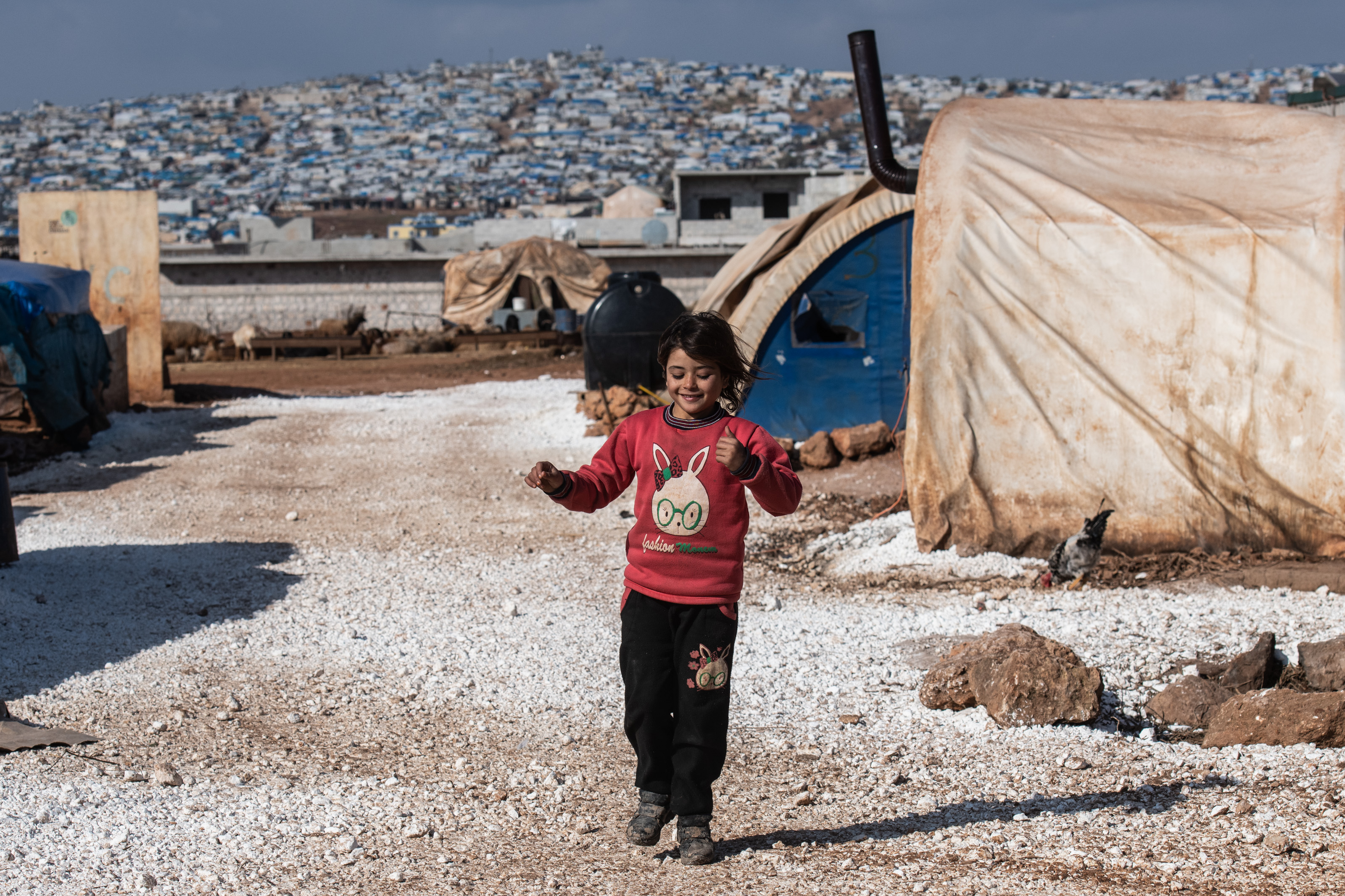 IDLIB, SYRIA - FEBRUARY 20: A displaced Syrian girl runs in a refugee camp in Atmeh village near the Syrian-Turkish border on February 20, 2020 in Idlib, Syria. Turkey’s President Recep Tayyi