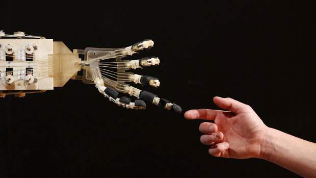 A robotic hand interacts with a person 