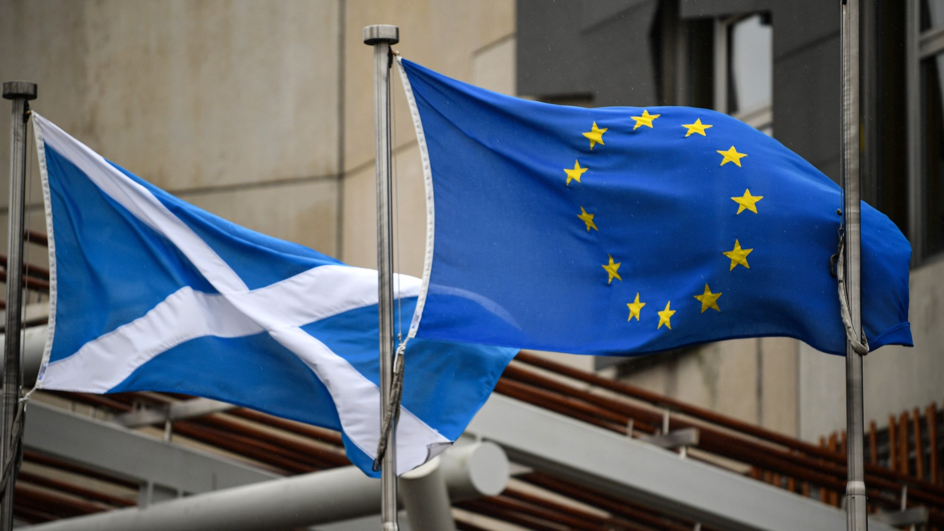 The Scottish Saltire and EU flag fly side by side in Edinburgh