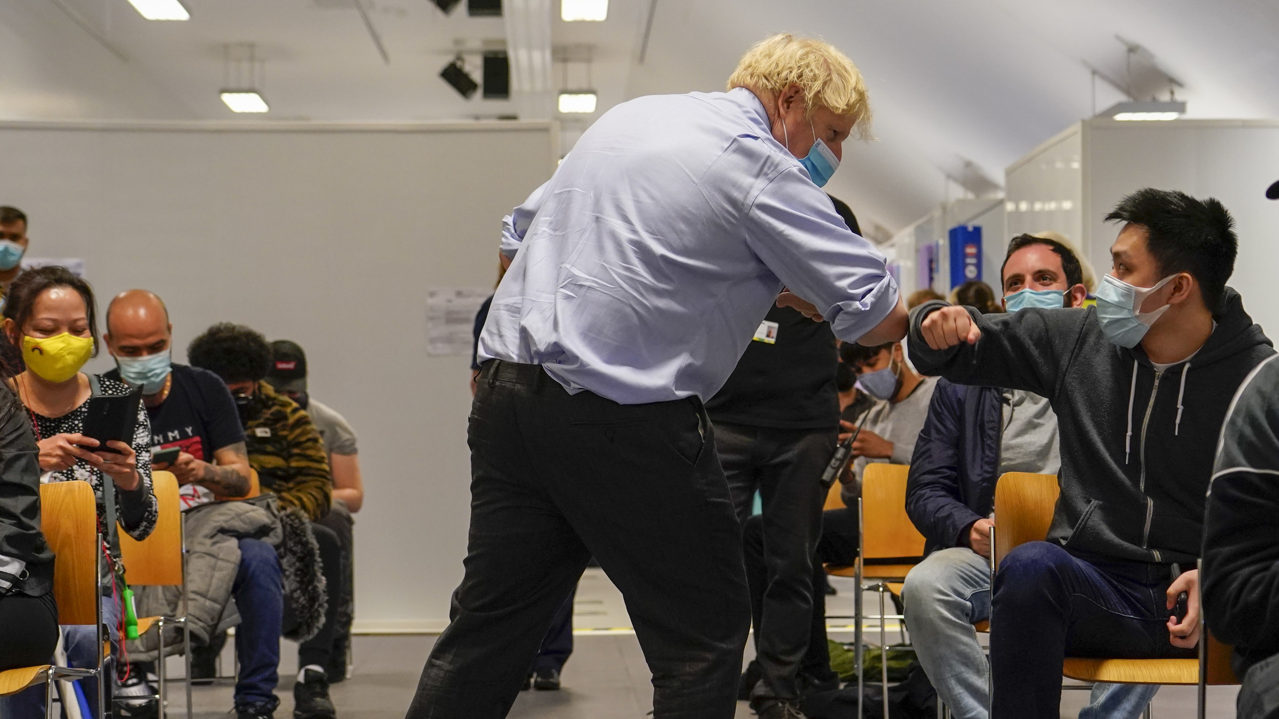 Boris Johnson meets patients during a visit to the vaccination centre