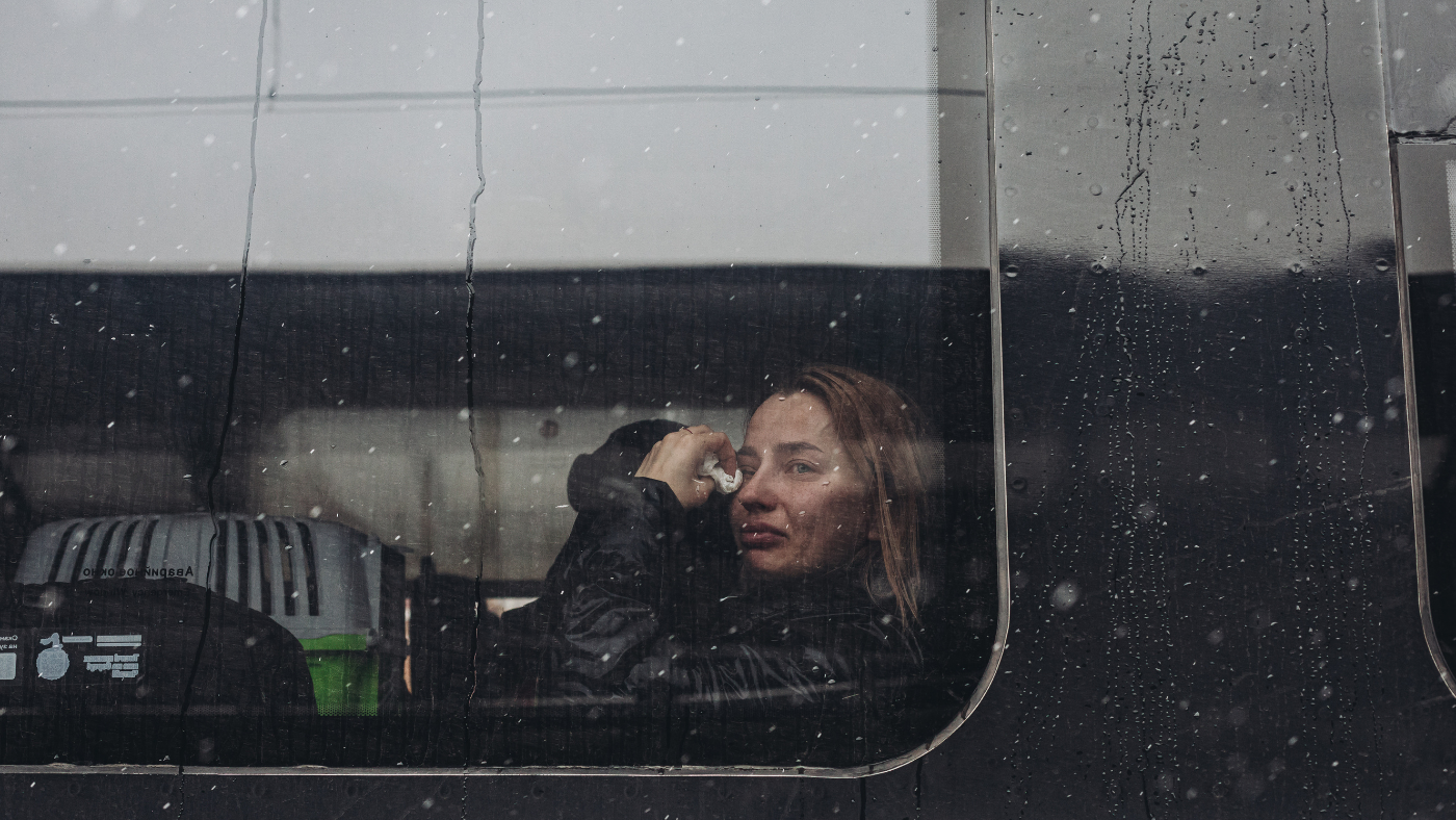 Woman cries on bus leaving Ukraine