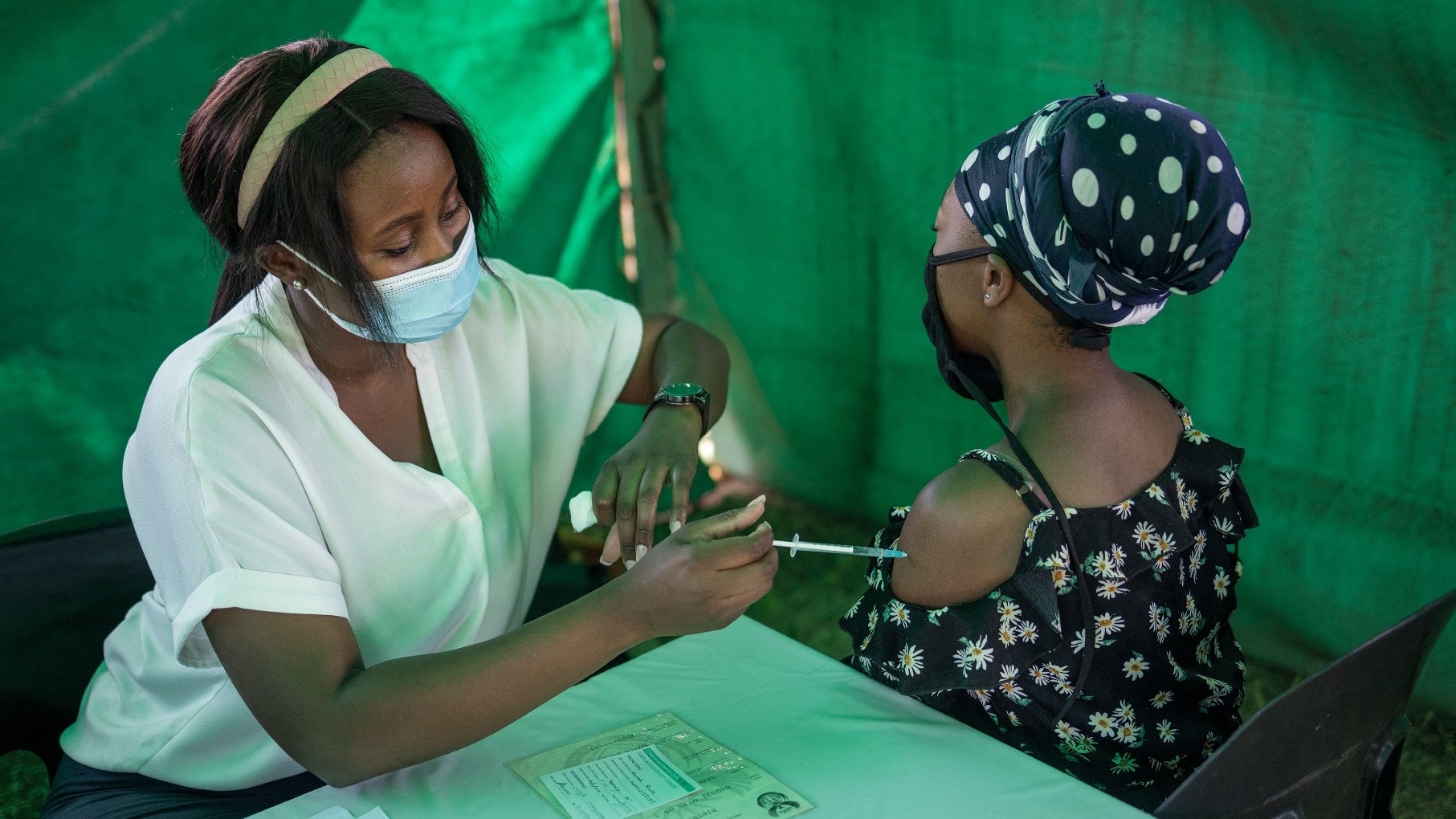 A healthcare worker vaccinates a woman in Soweto, South Africa