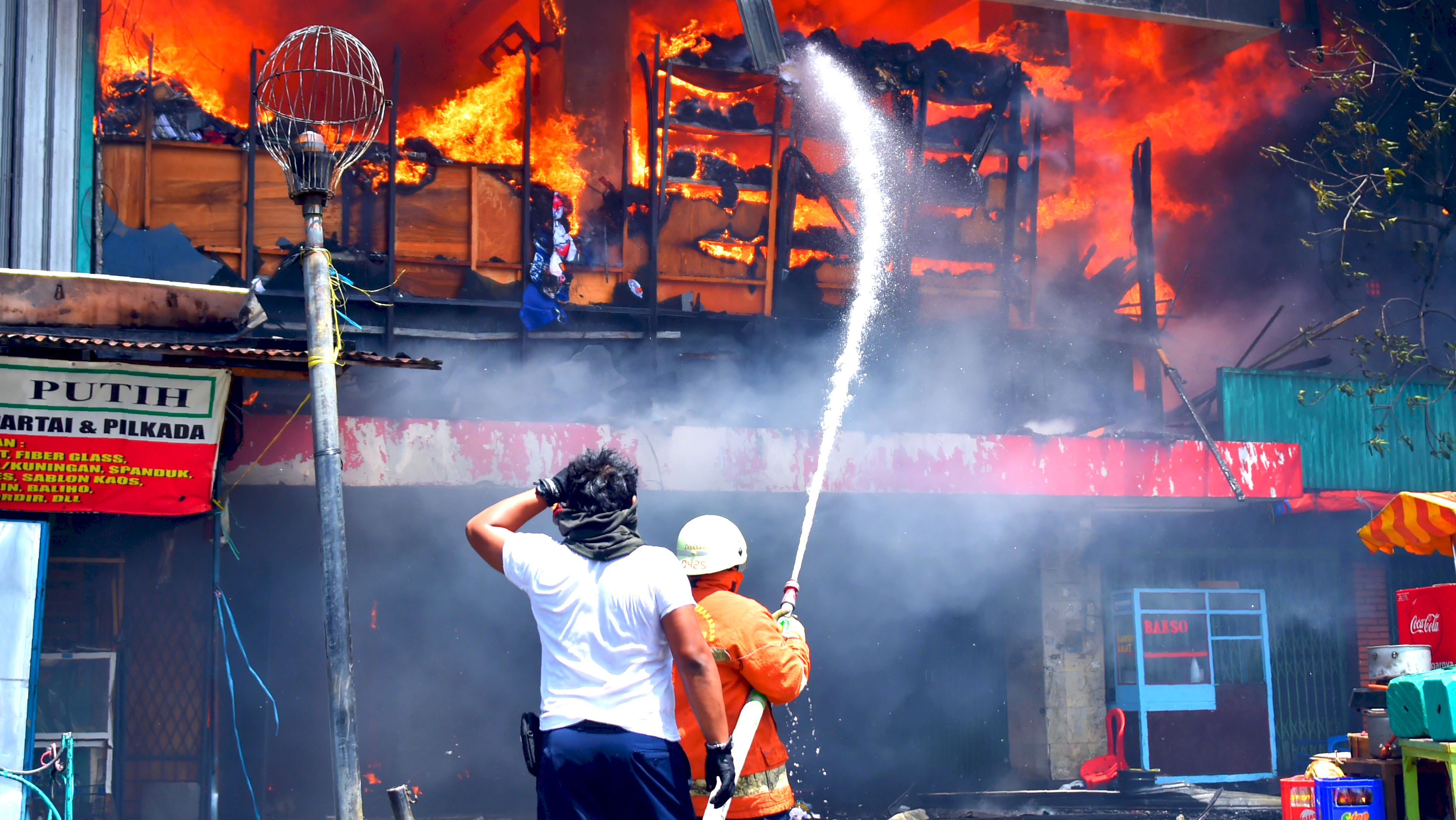 Firefighters battle a blaze at one of the biggest shopping centres in Jakarta