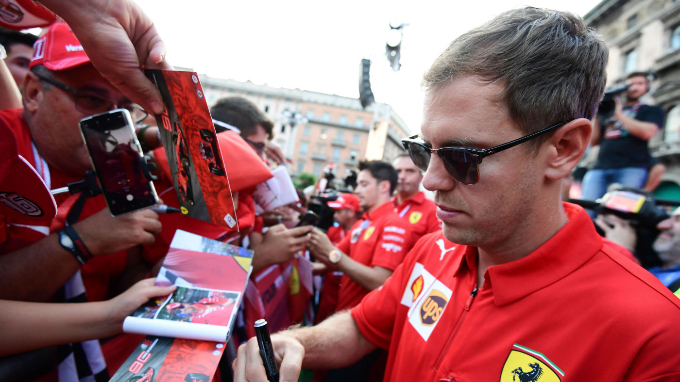 Sebastian Vettel signs autographs at a Ferrari event in Milan on 4 September 