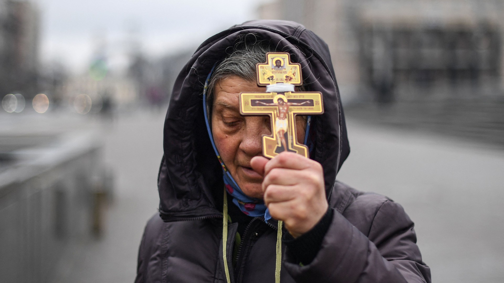 A woman prays on Independence Square in Kyiv, Ukraine