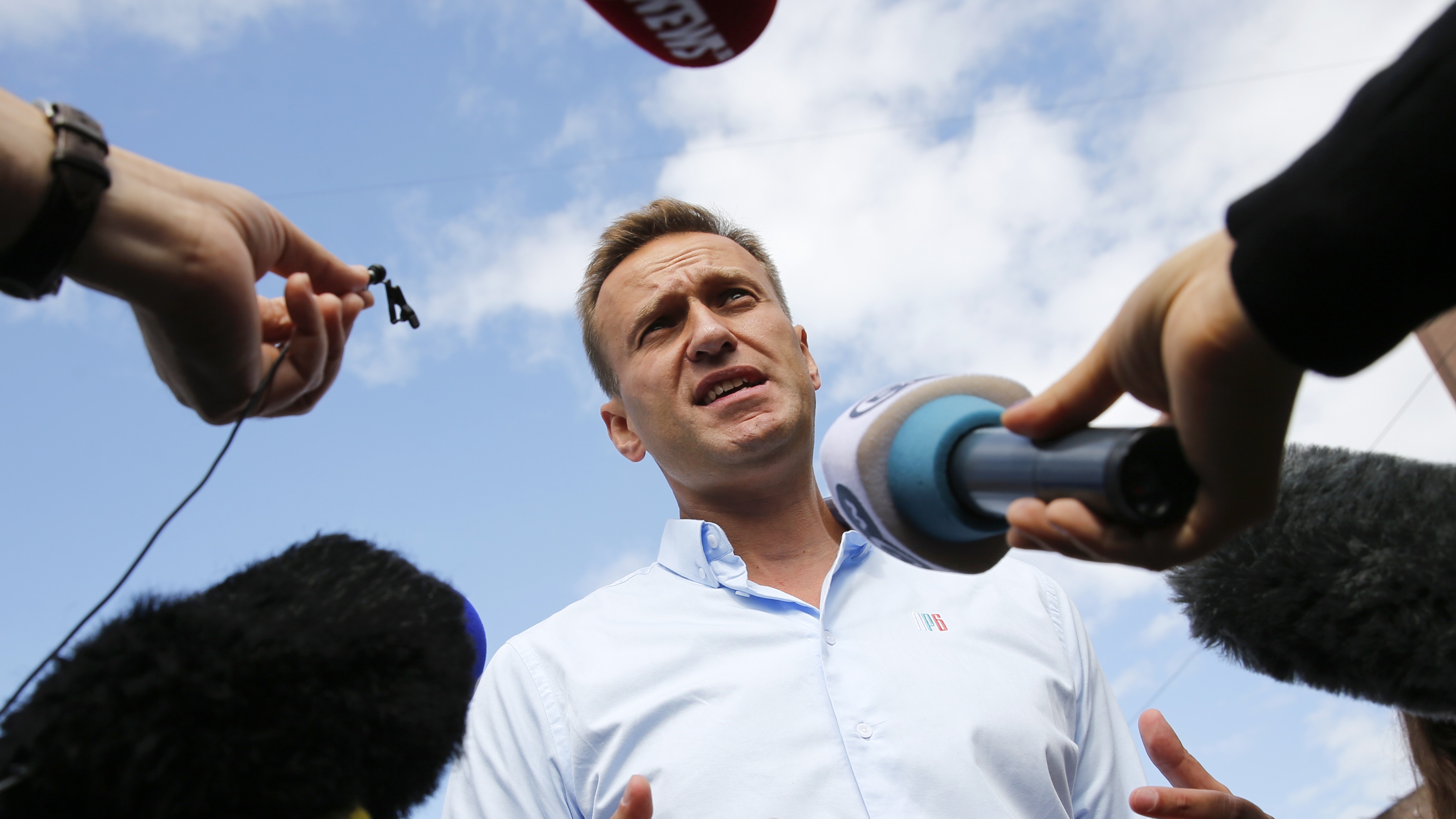 Alexei Navalny speaks with journalists during a rally