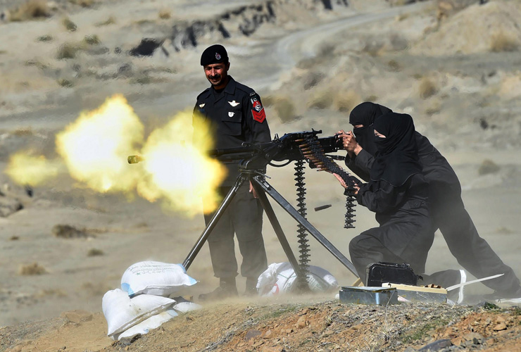 A Pakistani policewoman fires a heavy machine gun during a special elite police training course at a police training centre in Nowshera, a district in the Khyber Pakhtunkhwa Province on Febru