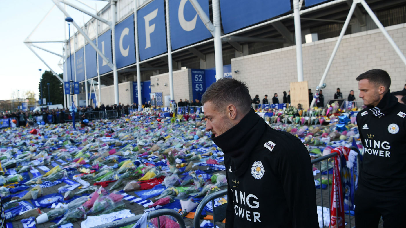 Leicester City striker Jamie Vardy looks at the floral tributes left to the victims of the helicopter crash