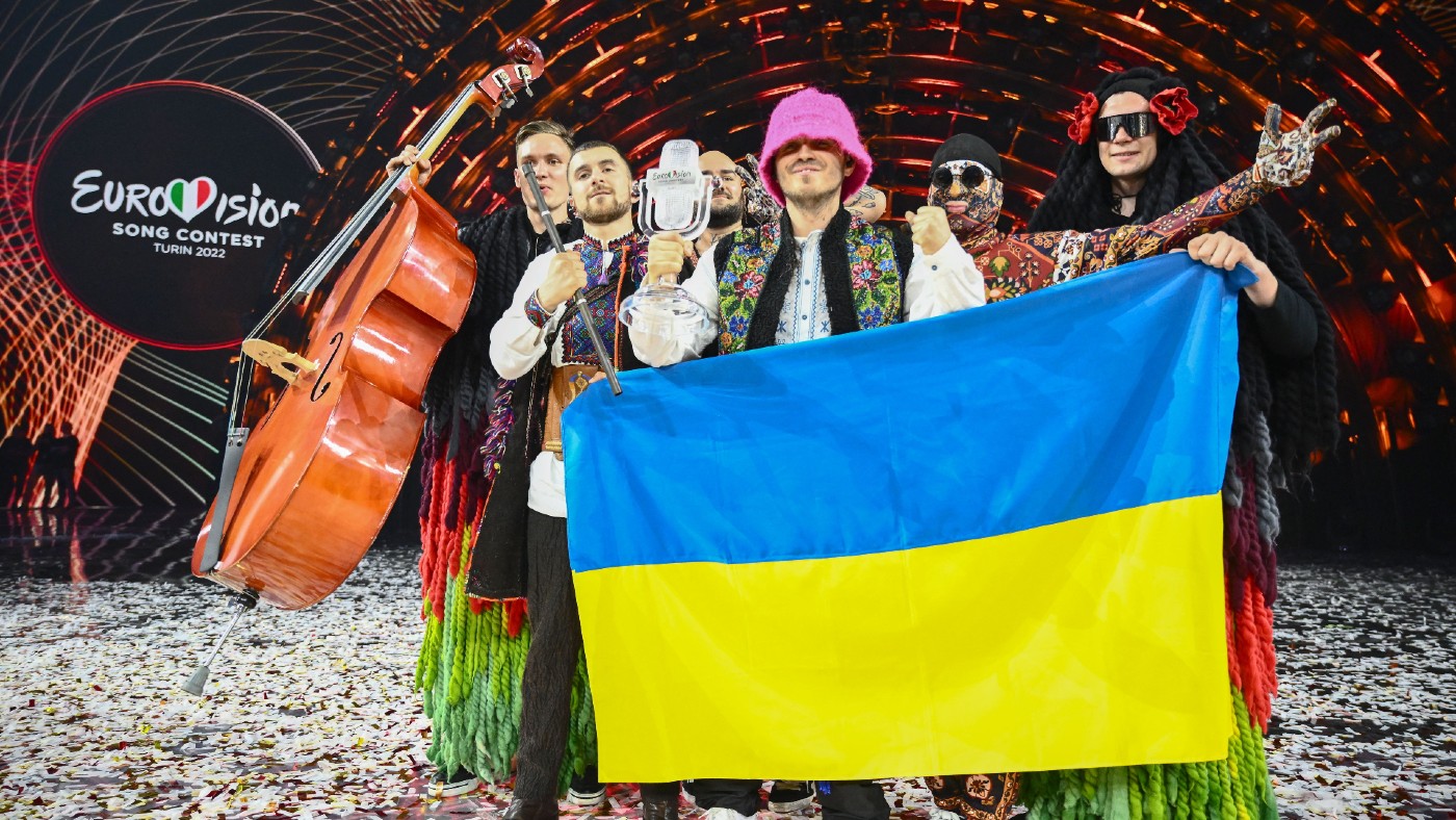  Members of the band Kalush Orchestra pose onstage with the Ukrainian flag