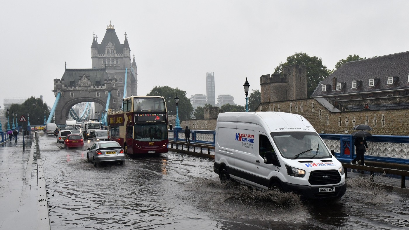 Motorists drive through large puddles on Tower Bridge road