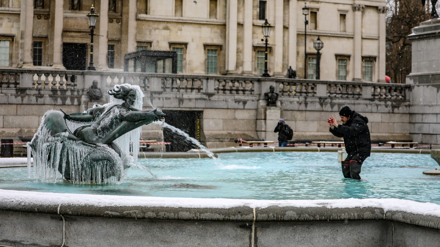 A man stands in a Trafalgar Square fountain