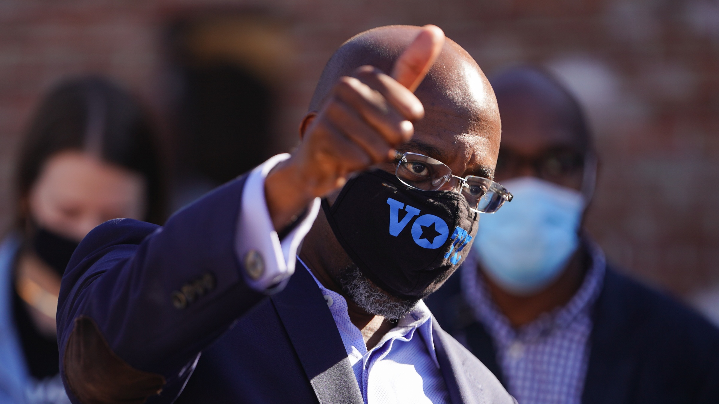 Democratic US Senate candidate Reverend Raphael Warnock gives a supporter a thumbs up at a campaign event