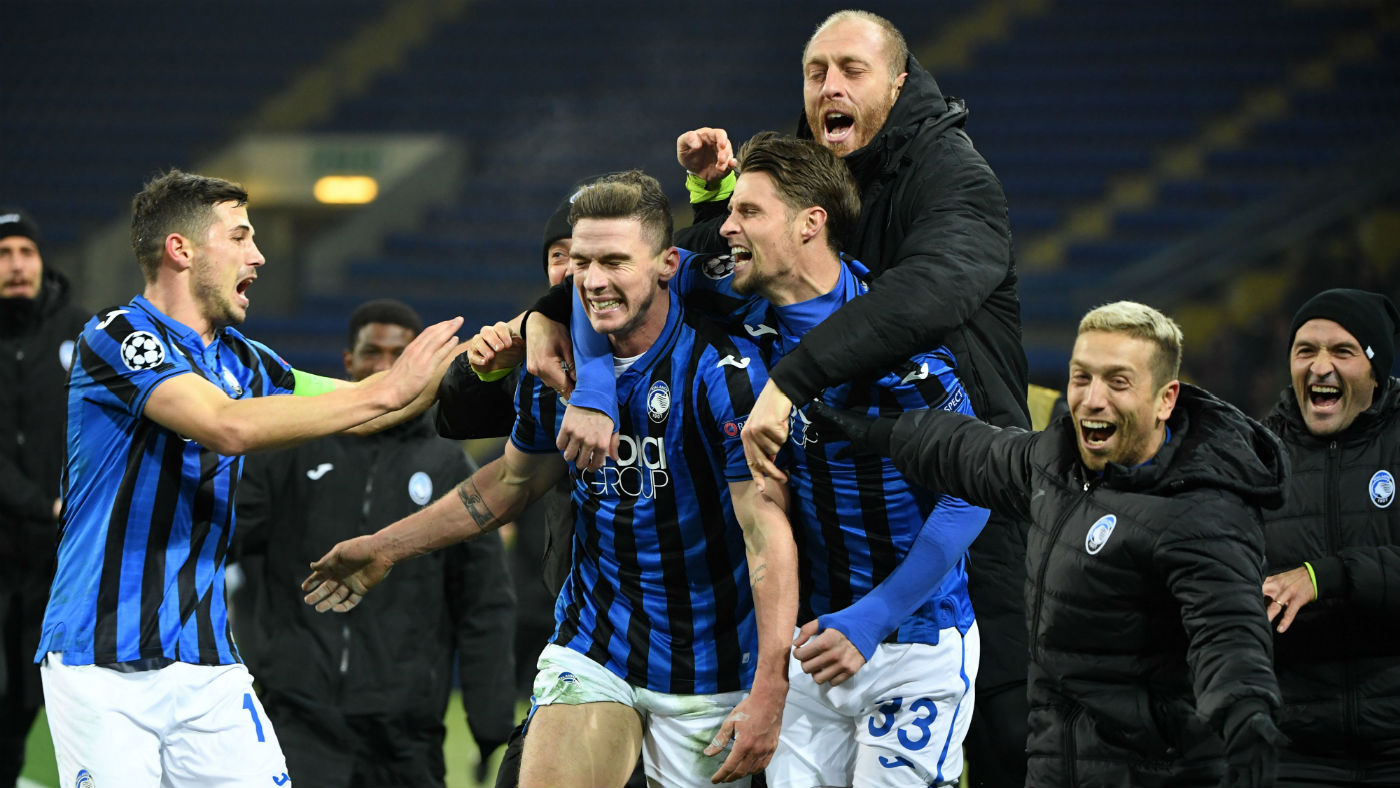 Atalanta players celebrate reaching the last 16 of the Champions League 