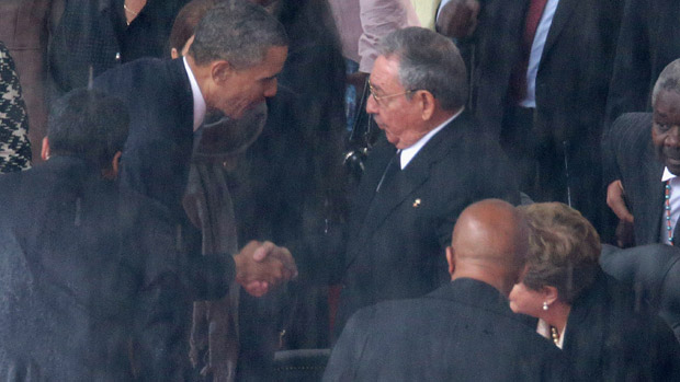US President Barack Obama shakes hands with Cuban President Raul Castro in South Africa in 2013
