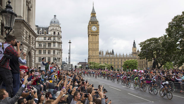 Crowds cheer as cyclists competing in the Tour de France
