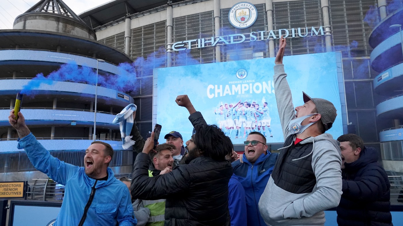 Man City fans celebrate their title win outside the Etihad Stadium 