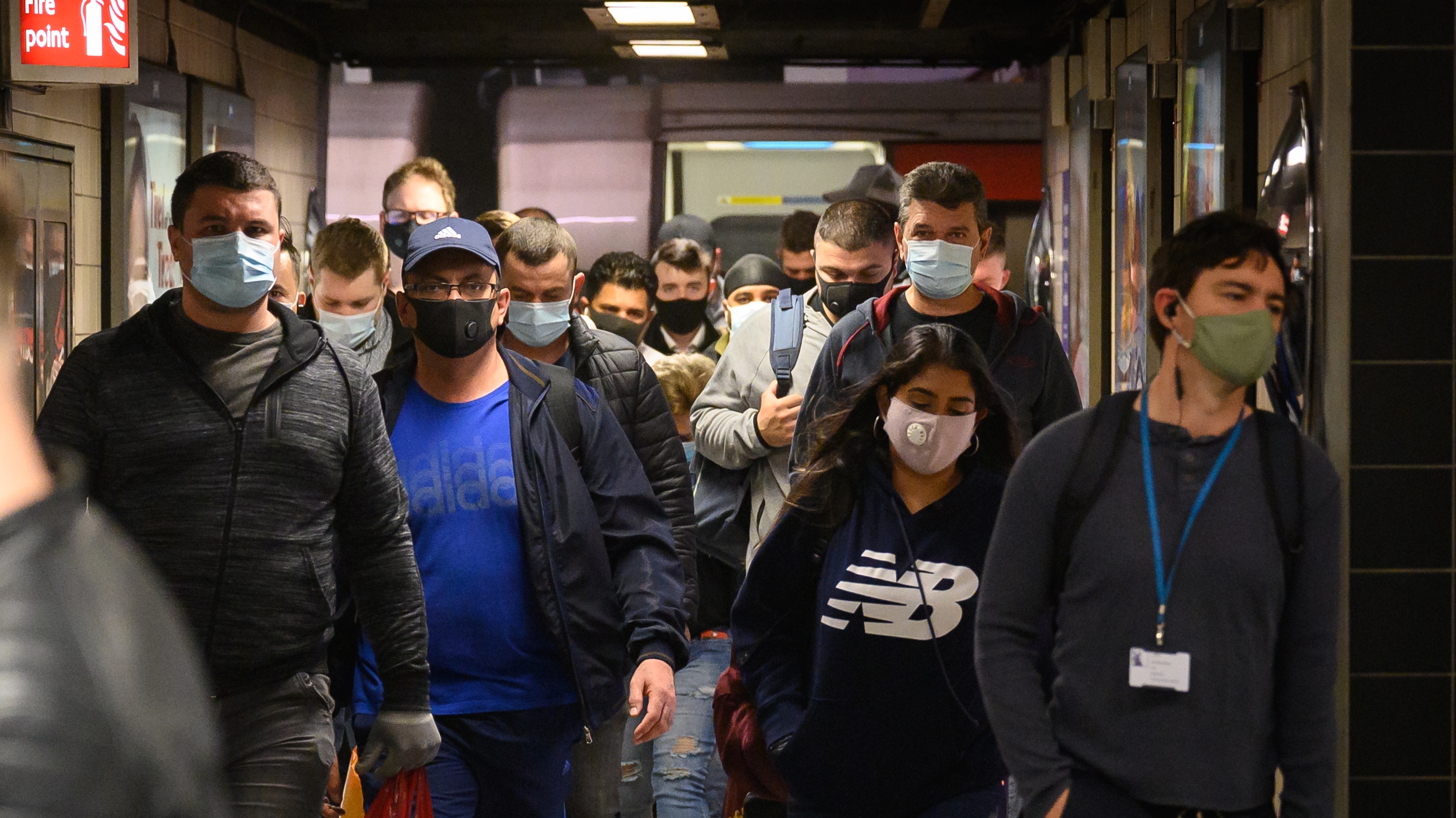 Commuters wear face masks as they pass through Vauxhall underground station.