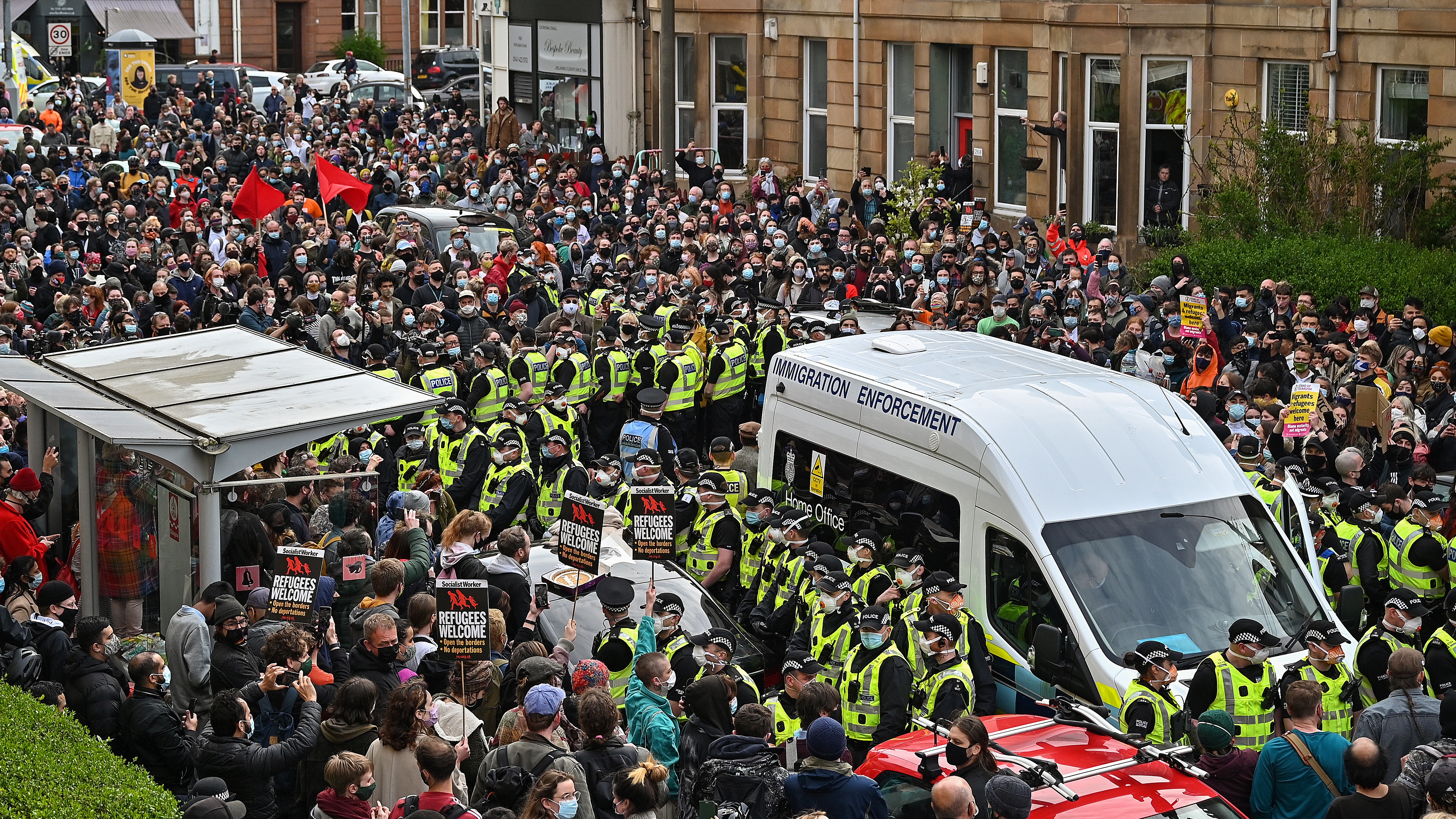 Protesters surround a UK Immigration Enforcement van in Glasgow