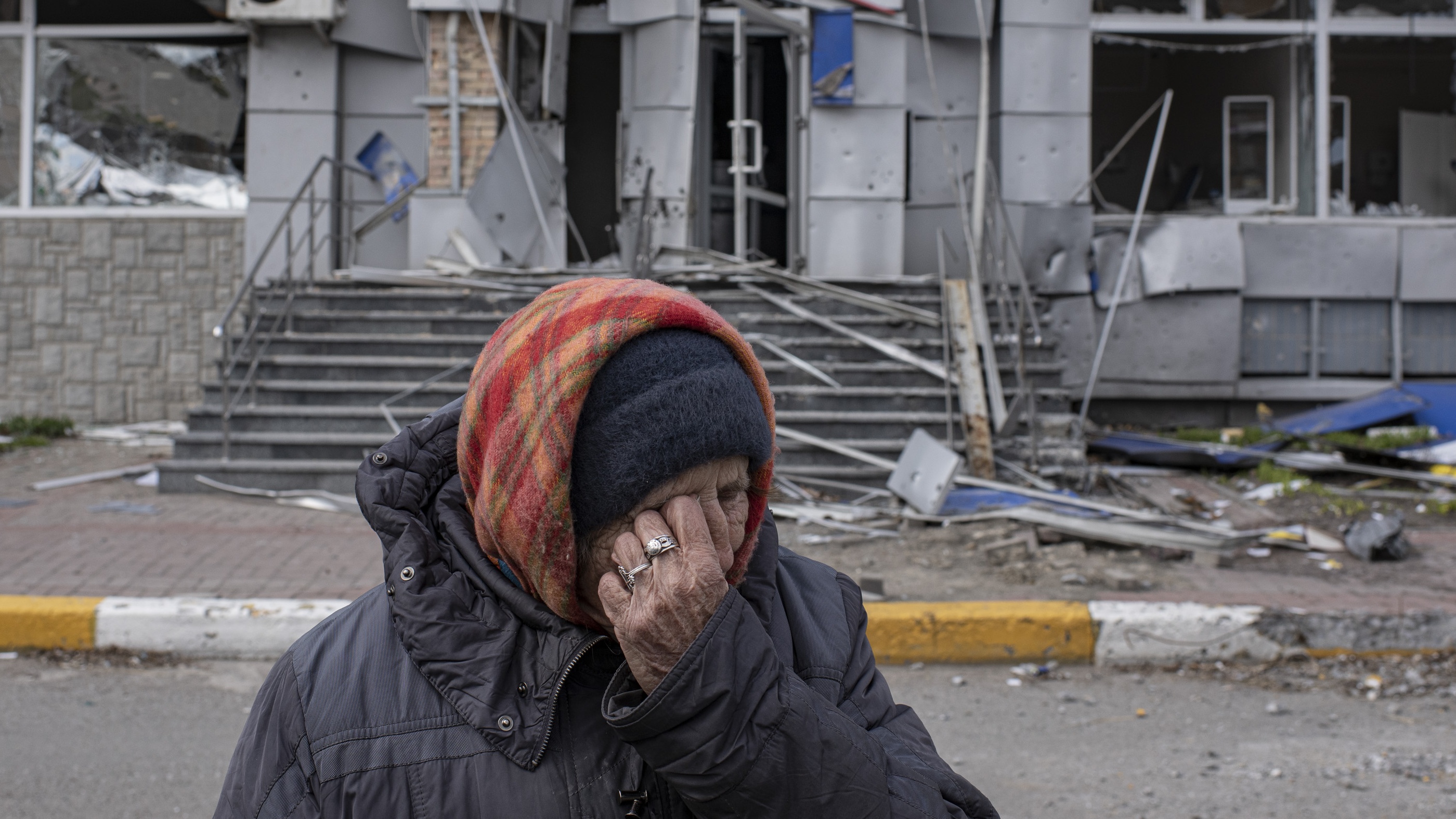 A Ukrainian woman cries after returning to her destroyed neighbourhood in Bucha