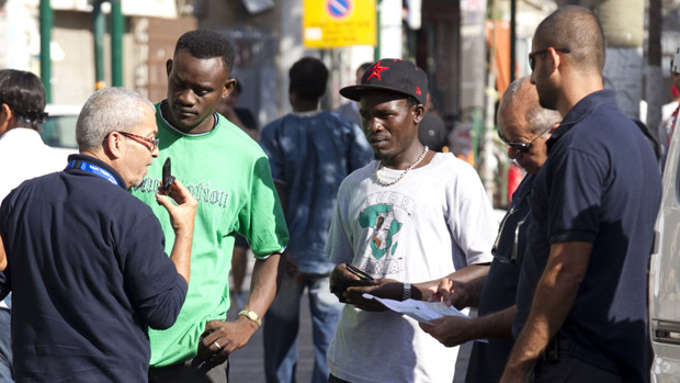 Israeli immigration officers checking African migrants