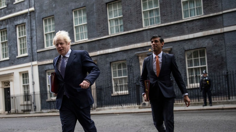 Boris Johnson and Rishi Sunak leave Downing Street to attend a meeting of the cabinet.