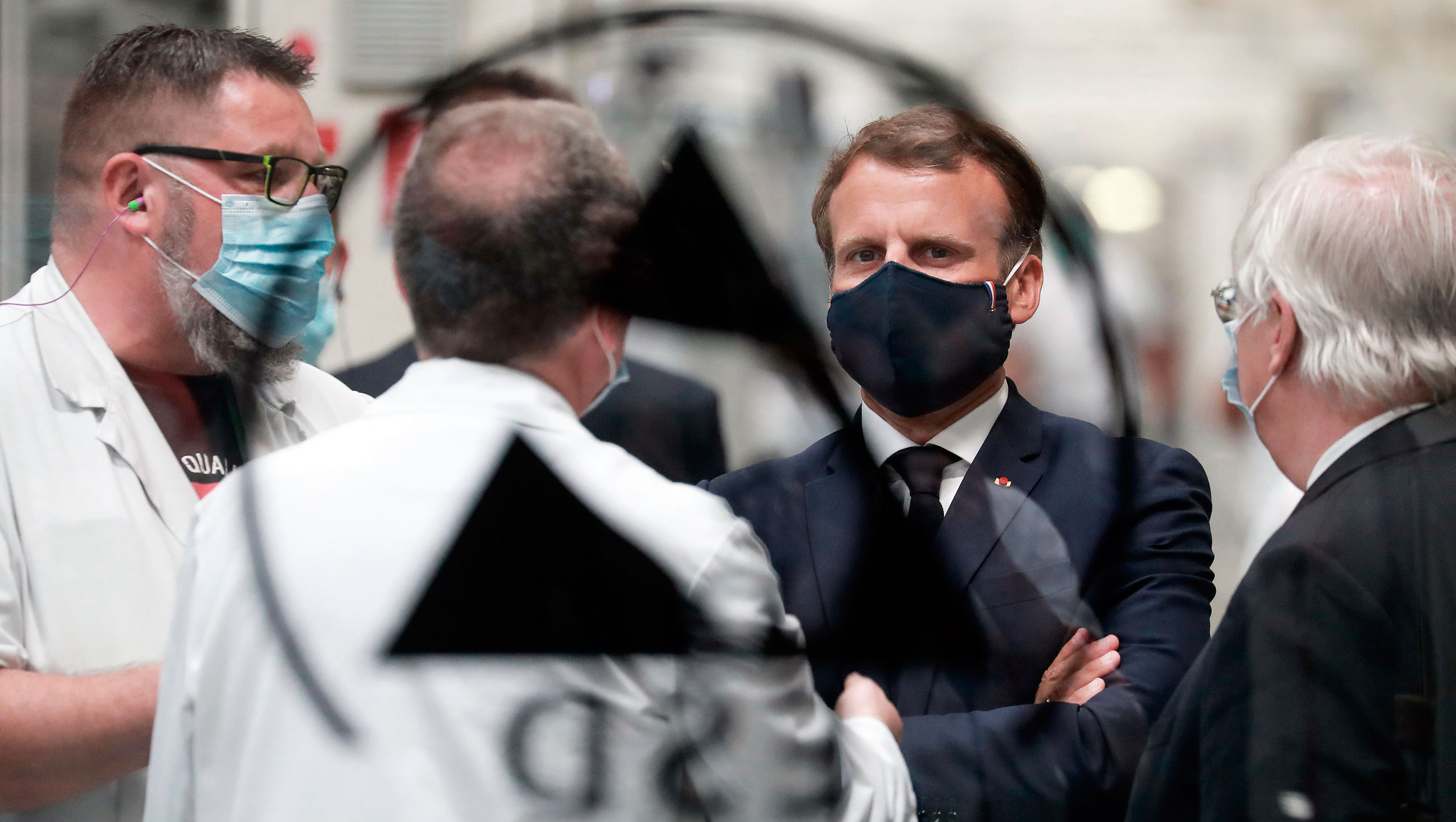President Macron wearing a mask during a visit to a car factory
