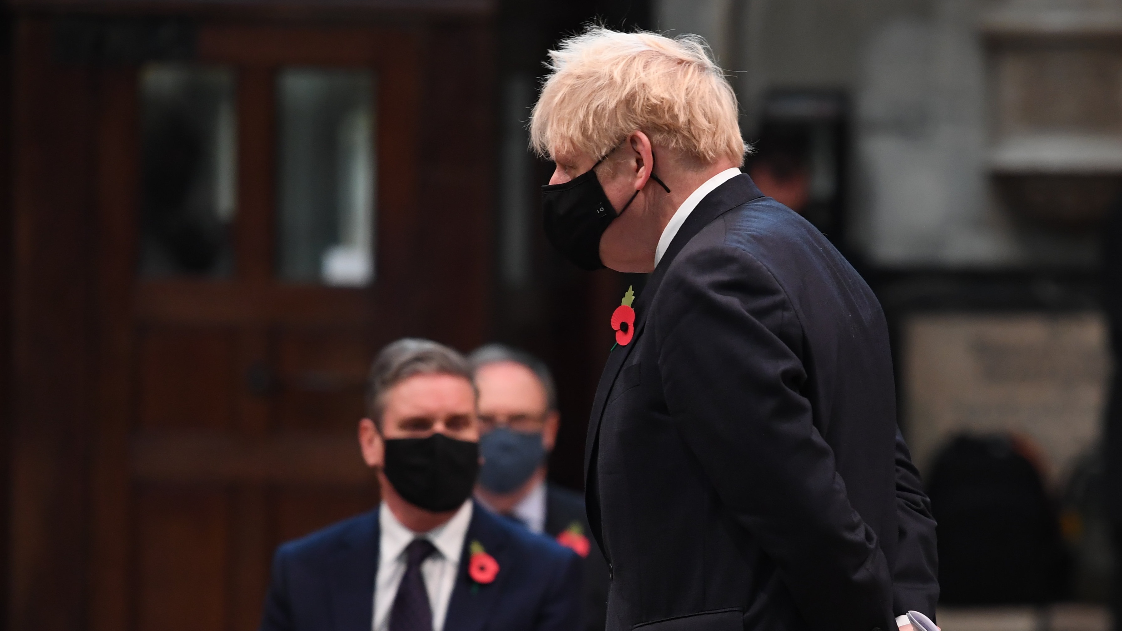 Boris Johnson passes by Keir Starmer as they attend a service to mark Armistice Day