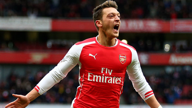 Mesut Ozil celebrates after scoring for Arsenal during the match between Arsenal and Aston Villa