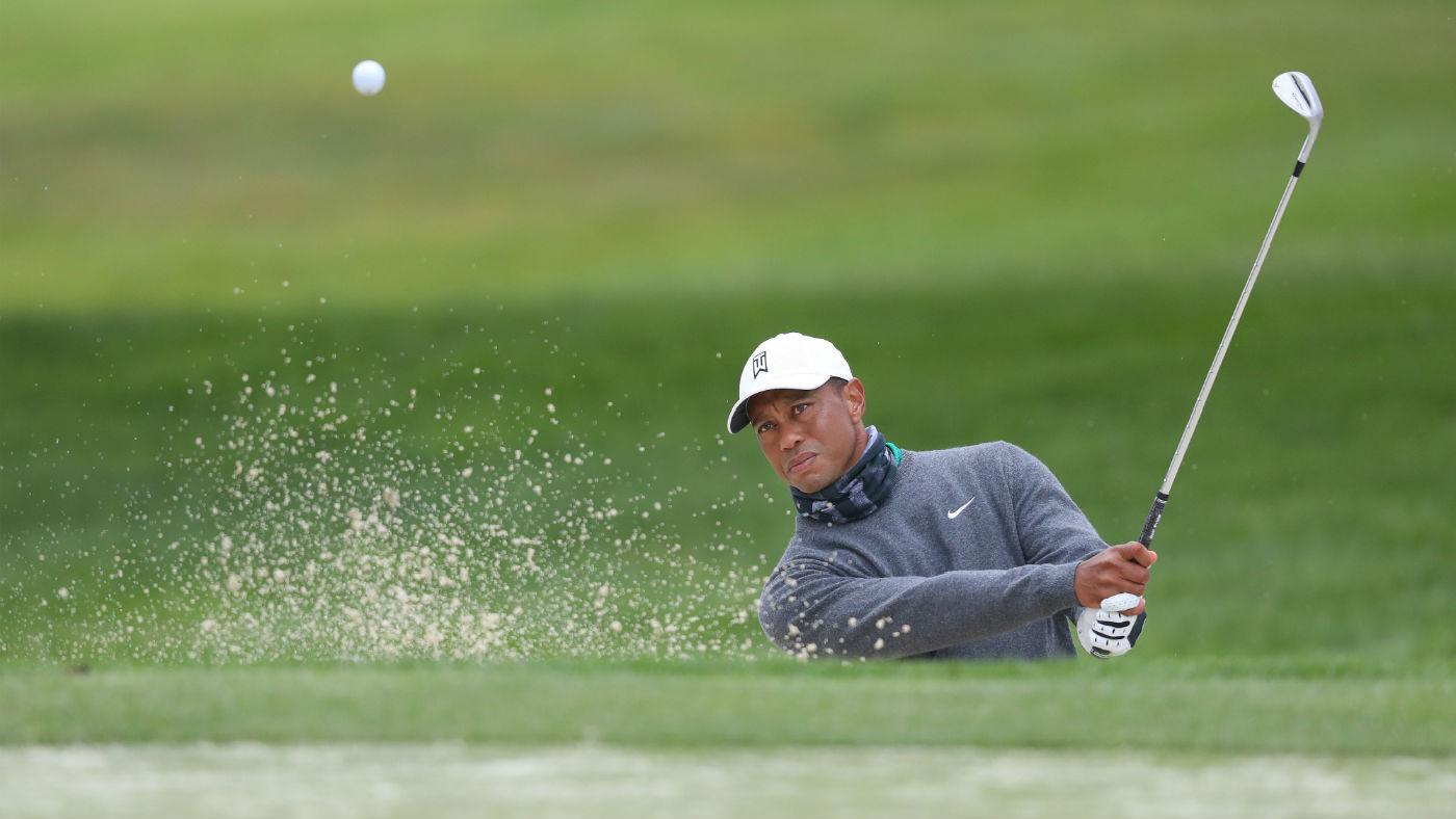 Tiger Woods plays out of the bunker during a PGA Championship practice round at TPC Harding Park
