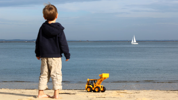 A child stands on the beach in Arcachon on October 19, 2013, southwestern France. AFP PHOTO / NICOLAS TUCAT(Photo credit should read NICOLAS TUCAT/AFP/Getty Images)