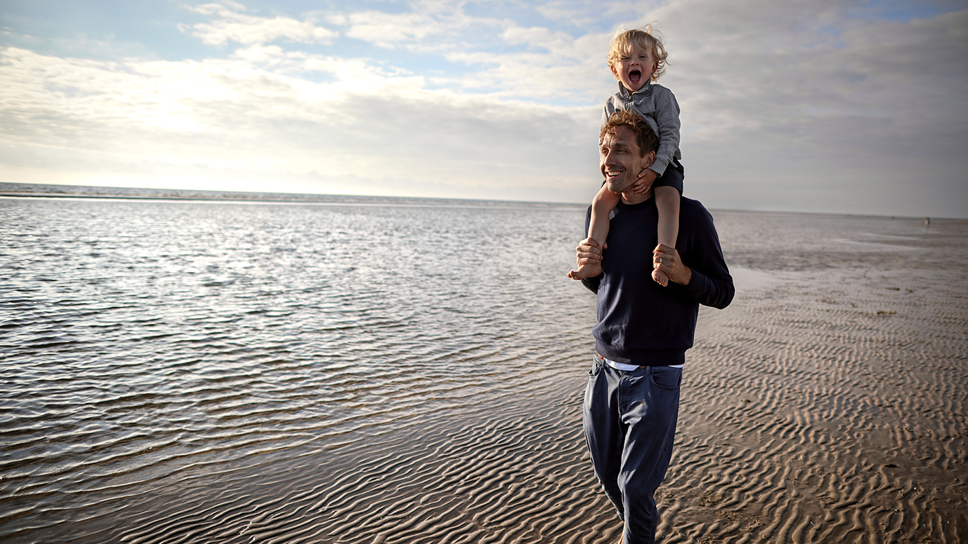 A father and child on the beach