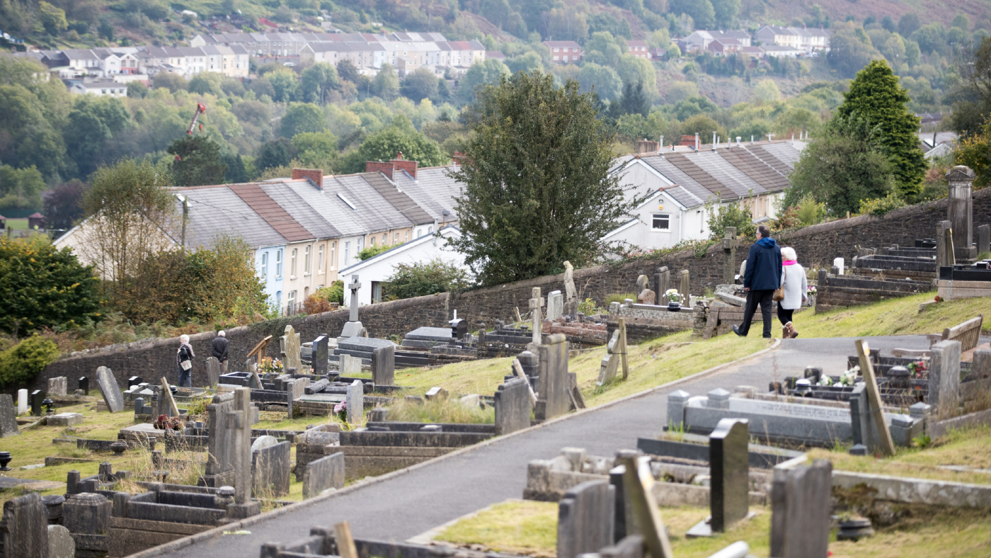 People walk in the cemetery