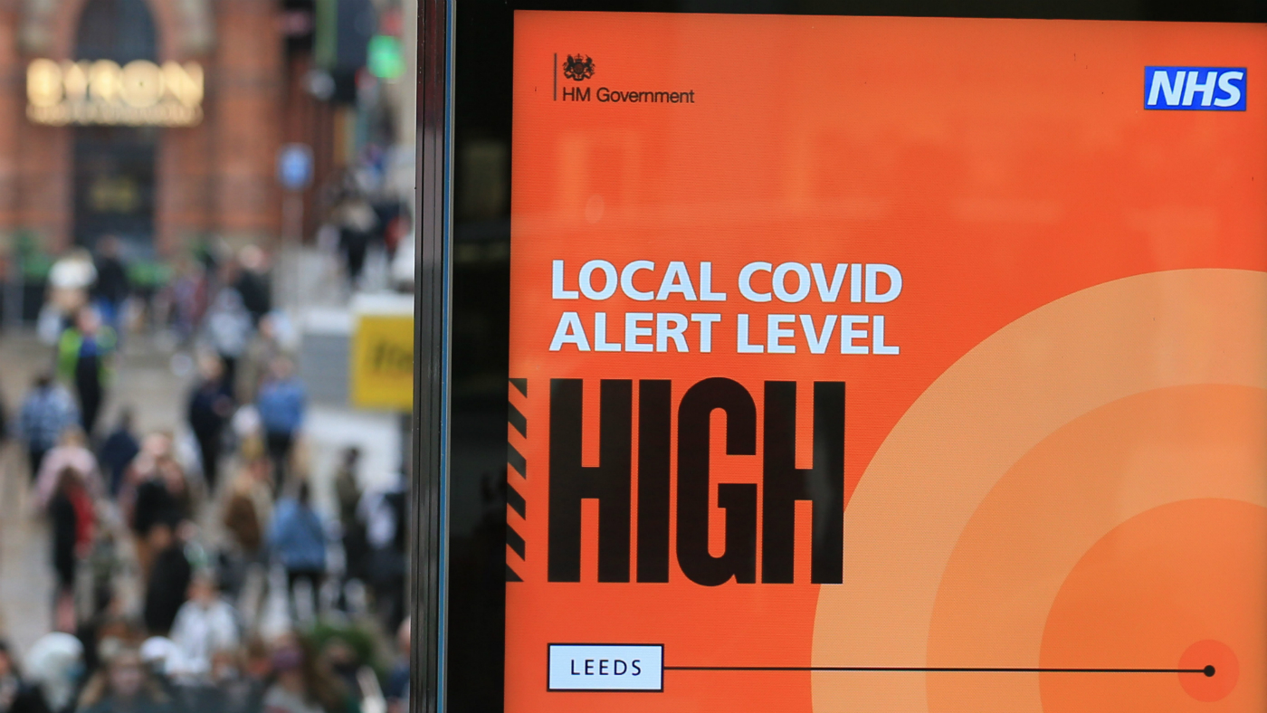 A bus stop in Leeds displays a sign warning that the Covid risk is high in the city.