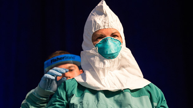 US health workers wearing protective medical gear against Ebola